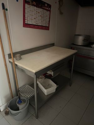 a table with a mop and buckets on it in a kitchen
