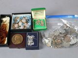 a lot of coins in a box and a coin in a box