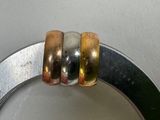 three rings that are sitting on top of a metal ring