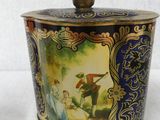 a small tin with a picture of a man and a woman on it
