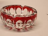 a red and clear glass bowl on a white surface