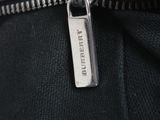 the zipper of a black leather jacket with a silver metal zipper