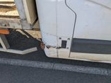 a white truck with a flat bed parked on the side of the road
