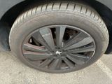 a black car with a flat tire on the street