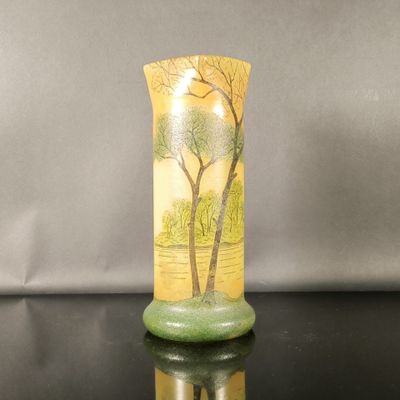 a vase that has a picture of a tree on it