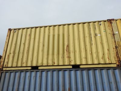 a yellow and blue container sitting on top of a building