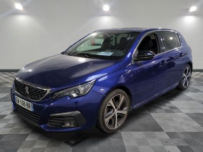 the blue car is parked on a checkered floor in a garage