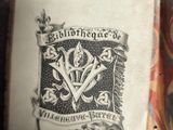 an old book with a picture of a coat of arms on it