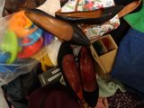 a pile of shoes and toys on the floor