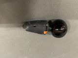 a small black object in the middle of a bathroom sink