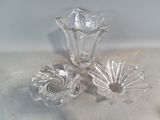 three pieces of glass sitting on a counter top