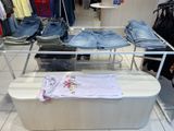 a display of jeans and other clothing in a store