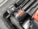 a close up of a red and black battery in a car