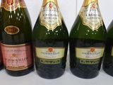 six bottles of champagne are lined up in a row on a table