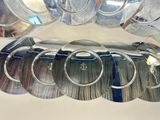 a lot of silver plates on a white table