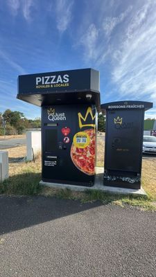 a black box with a pizza on it next to a road