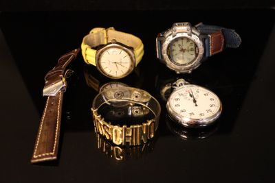 a lot of watches that are sitting on a table