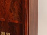 a very large wooden cabinet with a gold decoration on it