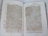 a book open on a table with a lot of writing on it