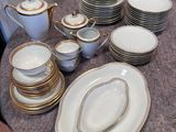 une table sur laquelle se trouvent beaucoup d'assiettes et de bols
