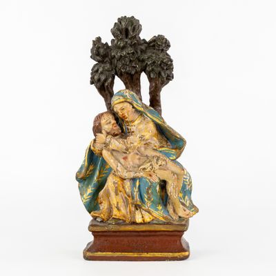 a statue of a woman holding a child in her lap