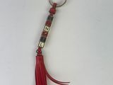 a keychain with a red tassel hanging from it