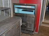 a small oven that is in the corner of a room