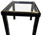 the table is black and gold with a glass top