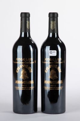 deux bouteilles de vin posées l'une à côté de l'autre sur une surface blanche