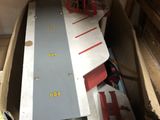 a cardboard box with a toy train set in it