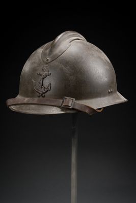 an old helmet on a stand against a black background
