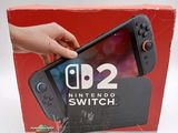 someone is holding a nintendo switch in front of a red box