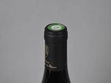 the bottle of wine is sitting on the table ready to be eaten