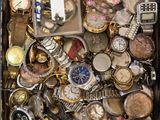 a suitcase full of assorted watches and other items