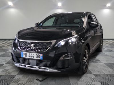 the front of a black car is parked on a checkered floor