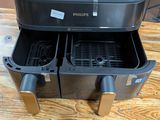 two deep fryers sitting on a wooden table