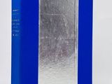 a blue and silver book sitting on top of a white table