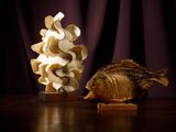 deux sculptures de poissons posées l'une à côté de l'autre sur une table