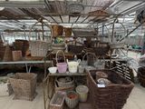 many baskets and baskets on display inside of a greenhouse