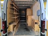 a white van with shelves in the back of it