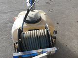 a machine with a hose attached to it sitting on the ground