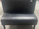 a black bench that is sitting in the middle of a room