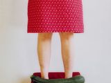 a woman standing on a scale with a cucumber in her hand