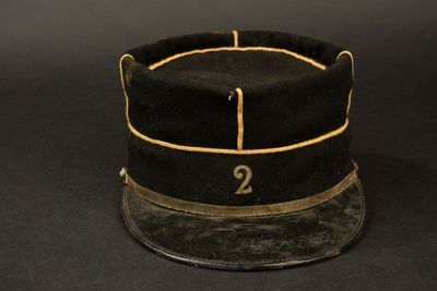 an old black hat with the number 2 on it on a black background