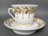 a close up of a coffee cup and saucer on a saucer