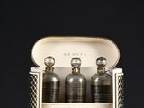 three bottles of perfume sitting in a case on a table