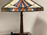 a close up of a lamp on top of a wooden table