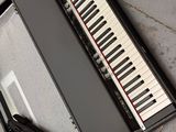 a keyboard in a case with a pair of scissors in it