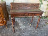 a small table with a drawer on it next to a dresser