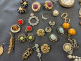 many different types of jewelry displayed on a table